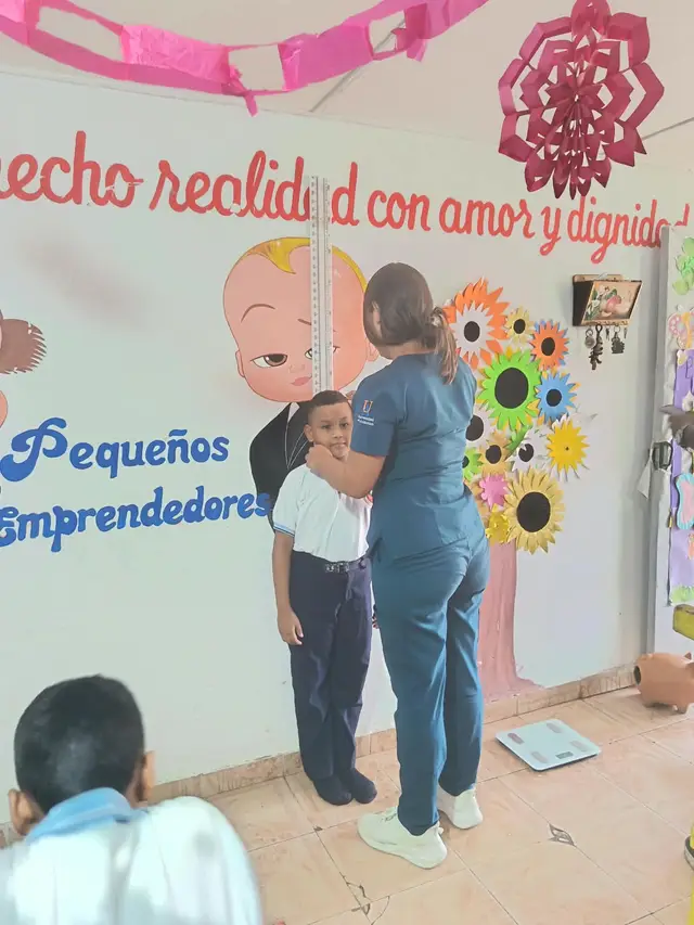 Medición de peso de un niño con el apoyo del banco de alimentos